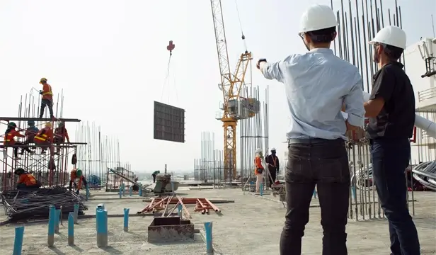 Two engineers working on the construction site