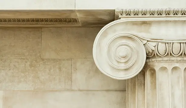 decorative top of a marble column on a court building